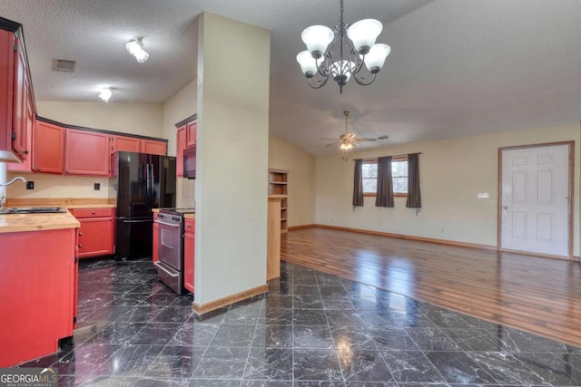 kitchen with stainless steel electric range oven, butcher block countertops, open floor plan, freestanding refrigerator, and a sink