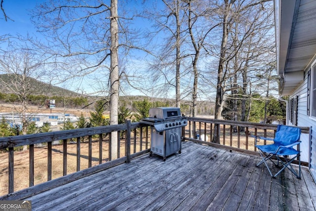 wooden terrace featuring a mountain view and grilling area