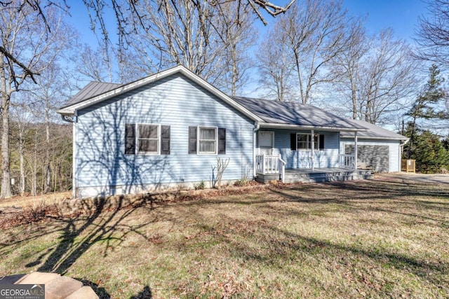 single story home featuring a porch, a front lawn, and an attached garage