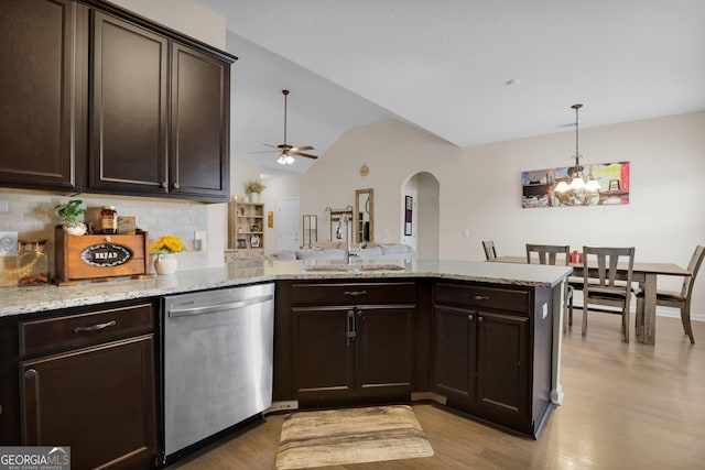 152 Summerhill Dr NE, Ludowici, GA 31316 - kitchen with dark brown cabinetry, arched walkways, dishwasher, a peninsula, and a sink