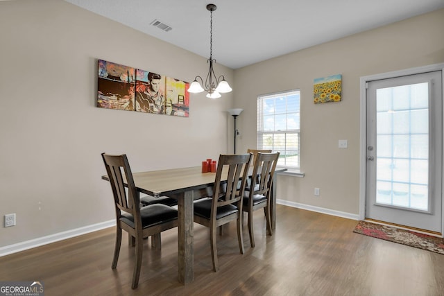 152 Summerhill Dr NE, Ludowici, GA 31316 - dining room with dark wood-style floors, a chandelier, visible vents, and baseboards
