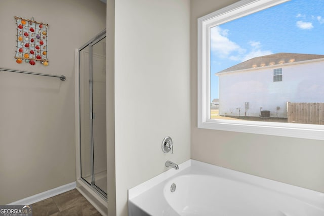 152 Summerhill Dr NE, Ludowici, GA 31316 - full bath with a wealth of natural light, tile patterned flooring, a garden tub, and a shower stall