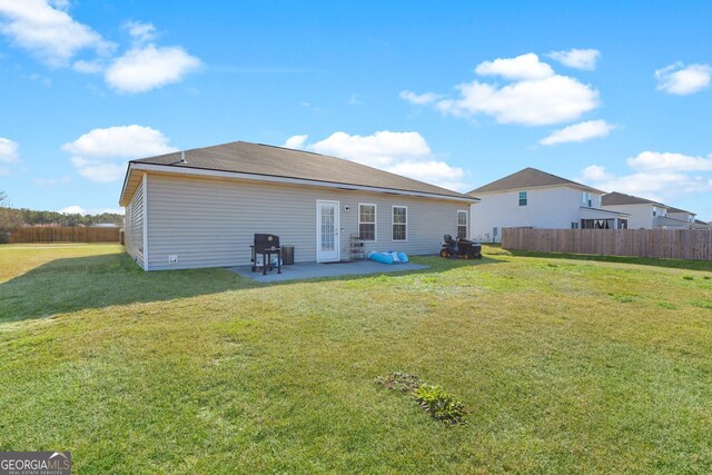 152 Summerhill Dr NE, Ludowici, GA 31316 - rear view of property featuring a yard, a patio area, and fence