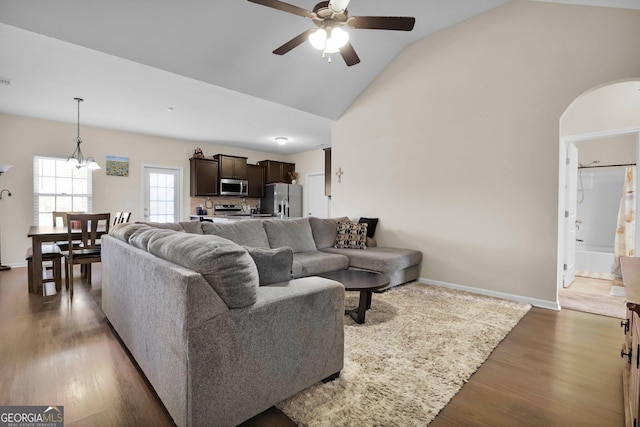 152 Summerhill Dr NE, Ludowici, GA 31316 - living area with arched walkways, high vaulted ceiling, ceiling fan, dark wood-style flooring, and baseboards