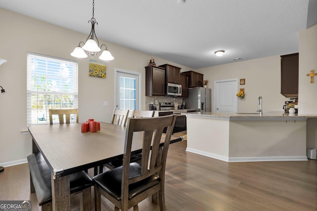 152 Summerhill Dr NE, Ludowici, GA 31316 - dining space featuring visible vents, baseboards, a chandelier, and dark wood-style flooring