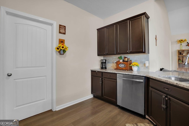 152 Summerhill Dr NE, Ludowici, GA 31316 - kitchen featuring light stone counters, dishwasher, a sink, and dark brown cabinets