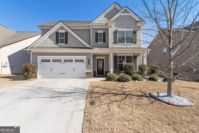 craftsman inspired home featuring concrete driveway and an attached garage