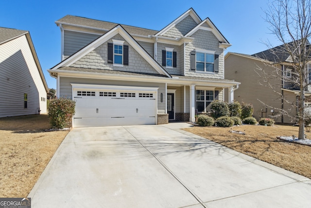 craftsman-style home featuring a garage and concrete driveway