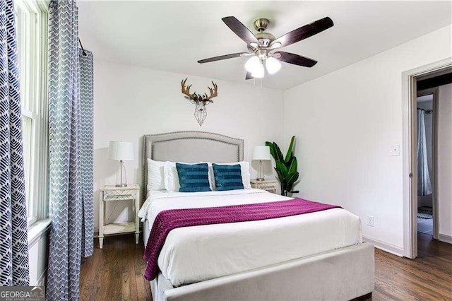 bedroom featuring dark wood-style floors, baseboards, and a ceiling fan