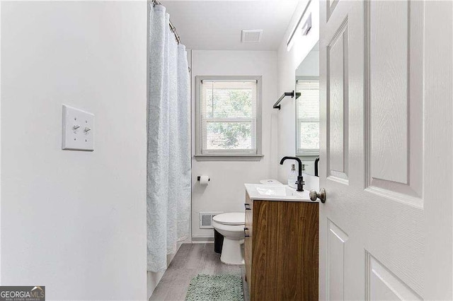 bathroom featuring toilet, visible vents, and vanity