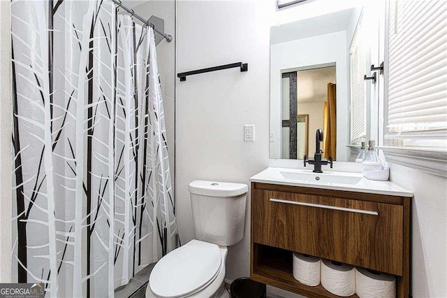 full bath with toilet and vanity