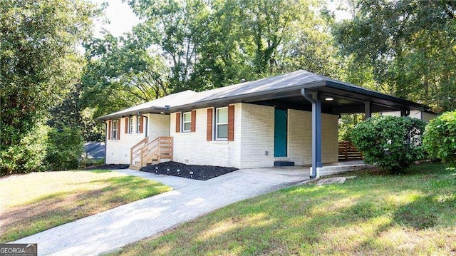 ranch-style home with a carport, concrete driveway, brick siding, and a front lawn