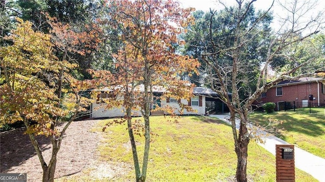 view of front of property with fence and a front lawn