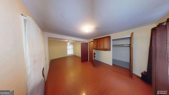 interior space with baseboards and wood finished floors