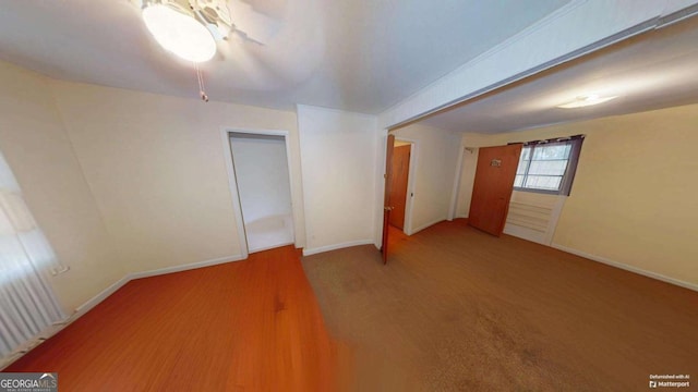 unfurnished room with wood finished floors and baseboards