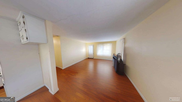 empty room featuring baseboards and wood finished floors