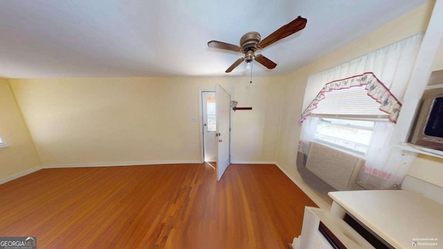 entryway with ceiling fan, wood finished floors, and baseboards