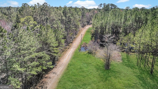 aerial view featuring a wooded view
