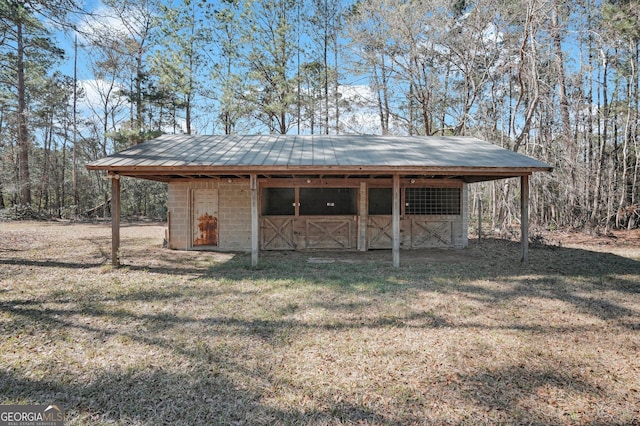 view of outbuilding featuring a carport, an outdoor structure, and an exterior structure