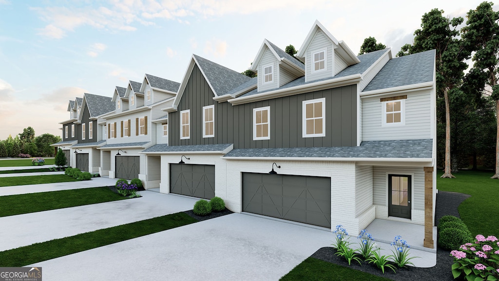 view of property featuring driveway, brick siding, board and batten siding, and an attached garage