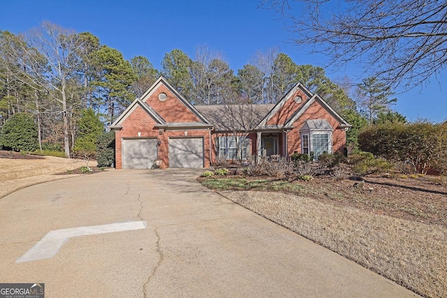 ranch-style home with brick siding, driveway, and an attached garage