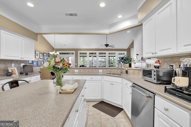 kitchen featuring light tile patterned floors, lofted ceiling, visible vents, a sink, and dishwasher