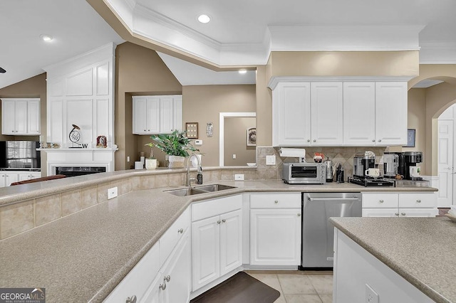 kitchen featuring light tile patterned floors, a sink, ornamental molding, stainless steel dishwasher, and backsplash