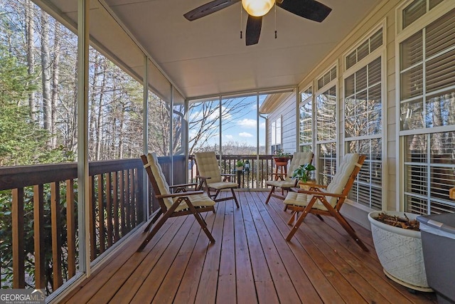 unfurnished sunroom with ceiling fan