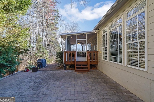 view of patio / terrace featuring a sunroom and a grill