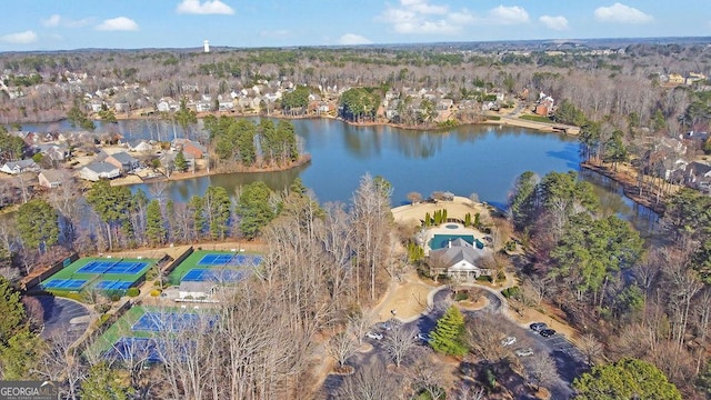 drone / aerial view featuring a water view and a wooded view