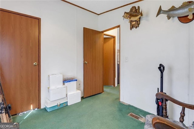 carpeted bedroom with ornamental molding and visible vents