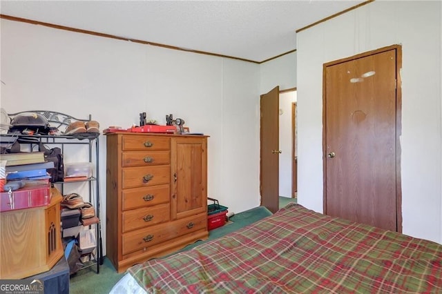 bedroom with dark colored carpet and ornamental molding