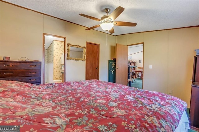 bedroom with a textured ceiling, ensuite bathroom, a ceiling fan, and crown molding