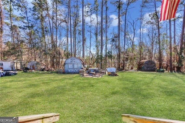 view of yard featuring an outbuilding and a shed