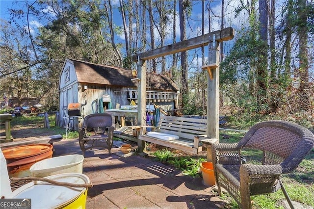 view of patio with an outbuilding and a storage unit