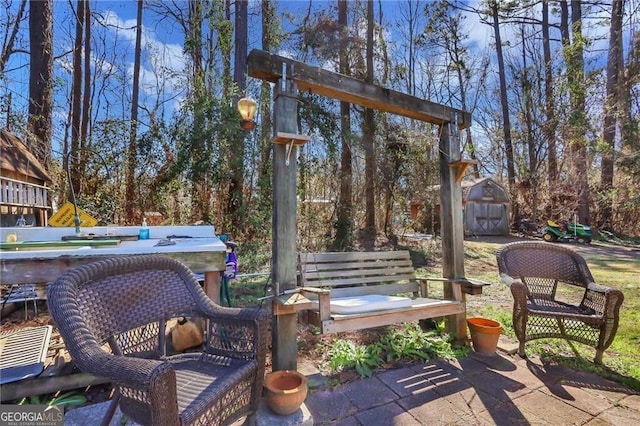 view of patio / terrace with an outbuilding and a shed