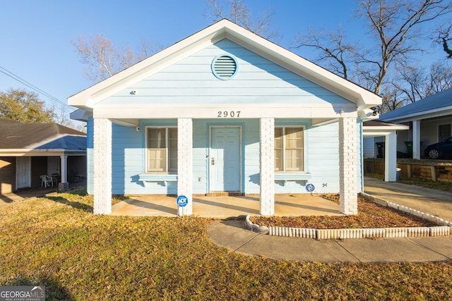 bungalow-style home featuring a porch and a front lawn