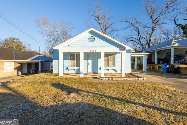 bungalow with a carport, concrete driveway, and covered porch