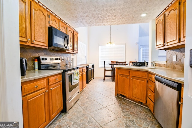 kitchen featuring stainless steel appliances, pendant lighting, light countertops, and brown cabinets