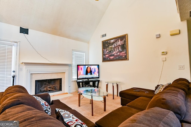 living area featuring visible vents, a premium fireplace, light carpet, high vaulted ceiling, and baseboards