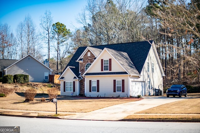 view of front of house featuring concrete driveway and a front yard