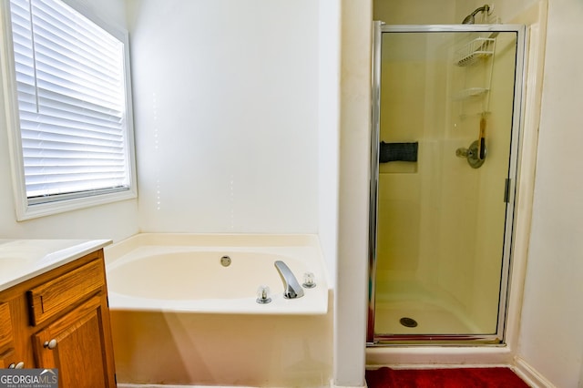 bathroom featuring a stall shower, vanity, and a bath