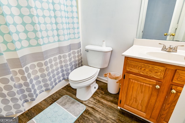 bathroom with a shower with curtain, vanity, toilet, and wood finished floors