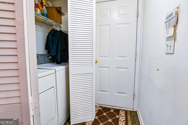 clothes washing area featuring laundry area, washer and clothes dryer, and baseboards