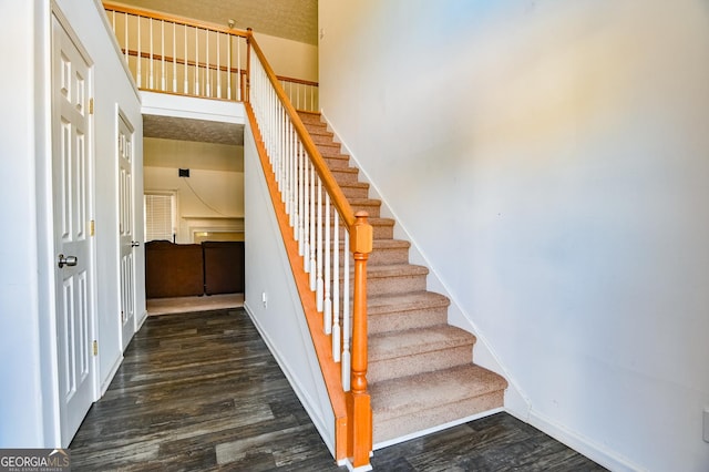 stairway featuring wood finished floors and baseboards