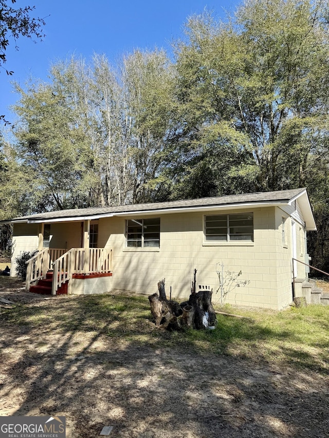 view of front facade with concrete block siding