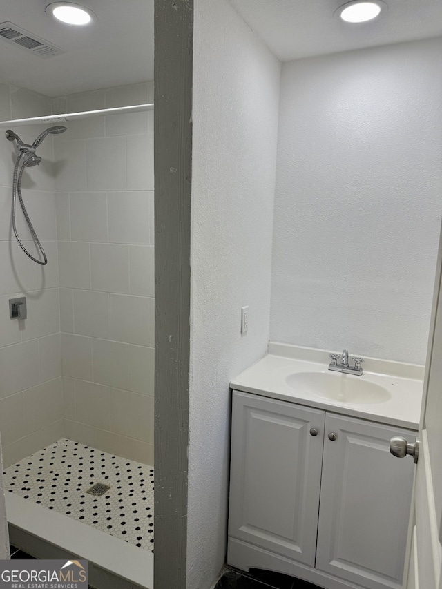 bathroom featuring a stall shower, visible vents, vanity, and recessed lighting