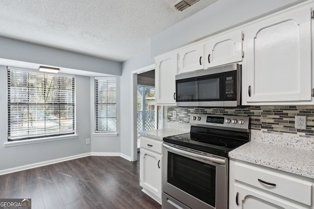 kitchen featuring white cabinets, tasteful backsplash, stainless steel appliances, and dark wood-type flooring