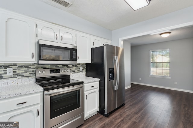 kitchen featuring dark wood-style floors, stainless steel appliances, light countertops, decorative backsplash, and white cabinets