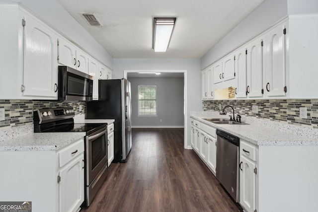 kitchen with stainless steel appliances, a sink, visible vents, and white cabinets